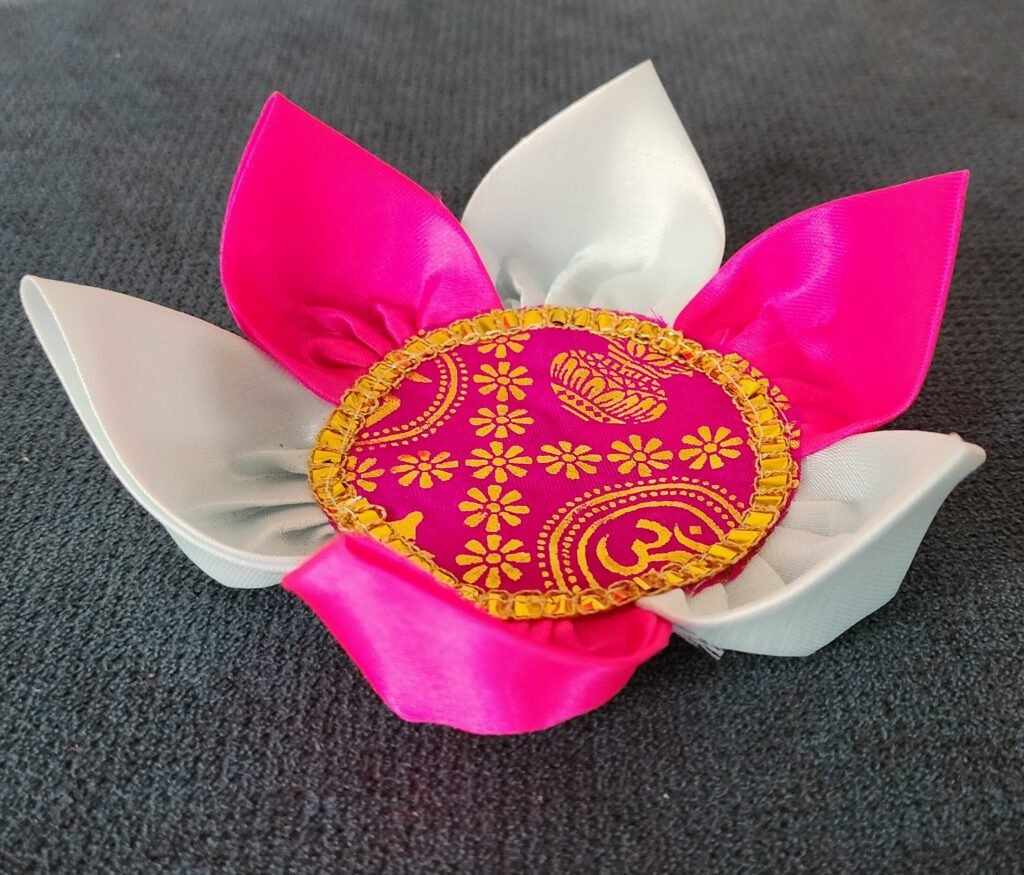Handmade multi-colored silk pooja lotus with pink and white petals and gold-decorated center, 7.5 cm diameter.