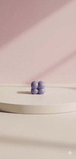 Peach wax candle with shimmering pink pearl bubble top in a low clear glass cup