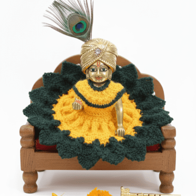 Laddu Gopal idol wearing yellow and green hand-knitted woolen dress seated on wooden base