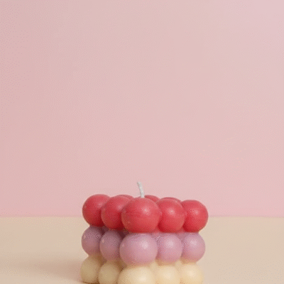 Handcrafted multicolour bubble cube scented wax candle with red, pink, and cream gradient design