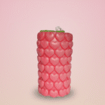 Layered red and cream scented wax candle in glass jar topped with miniature wax flowers