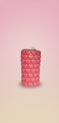 Layered red and cream scented wax candle in glass jar topped with miniature wax flowers