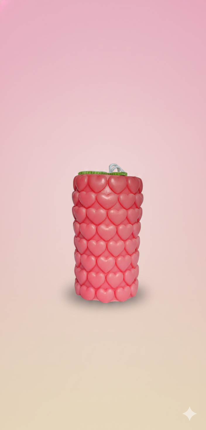 Layered red and cream scented wax candle in glass jar topped with miniature wax flowers