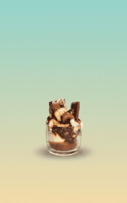 “Chocolate dessert-style scented wax candle with brownie chunks and chocolate bar toppers in a glass jar”