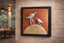 “Handmade terracotta bird wall art with textured base in contemporary folk design”
