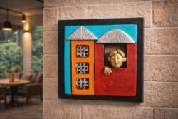 “Handmade terracotta wall art of a man looking out of a colorful window decorative piece”