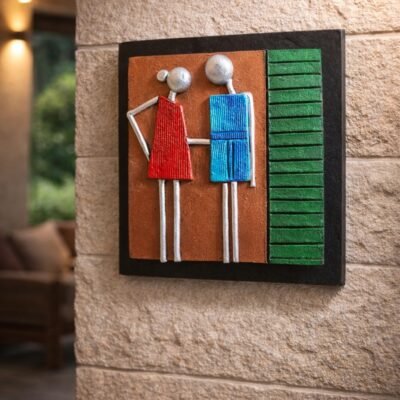 “Handmade terracotta couple wall art showing a man and woman holding hands in contemporary folk design”