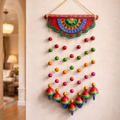 “Handmade terracotta hanging decorative with colorful bells and beads for traditional Indian wall décor”