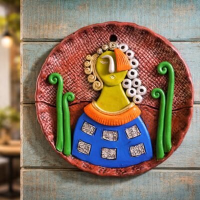 Handcrafted terracotta woman wall art with butterfly motifs. A contemporary folk décor piece perfect for artistic home interiors.