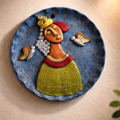 “Handmade terracotta tribal woman wall art decorative plate with butterfly motifs in contemporary folk style”