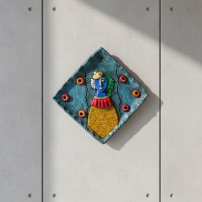 “Handmade terracotta woman wall art decorative plate with diamond shape and contemporary folk design”