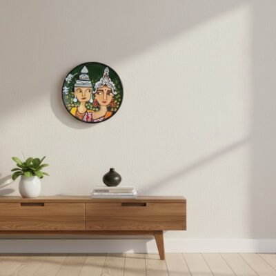 “Hand-painted terracotta wall plate of Bengali wedding couple in traditional topor and mukut with green background”