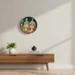 “Hand-painted terracotta wall plate of Bengali wedding couple in traditional topor and mukut with green background”