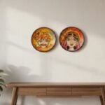 “Hand-painted Rajasthani bride and groom terracotta wall plates with orange-yellow gradient background”