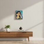 “Hand-painted wooden plaque with Kalighat-style portrait of Indian woman in saree”