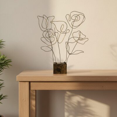 “Minimalist black and gold wire floral sculpture on distressed block base – abstract tabletop décor”