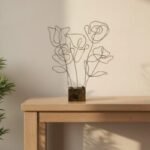 “Minimalist black and gold wire floral sculpture on distressed block base – abstract tabletop décor”