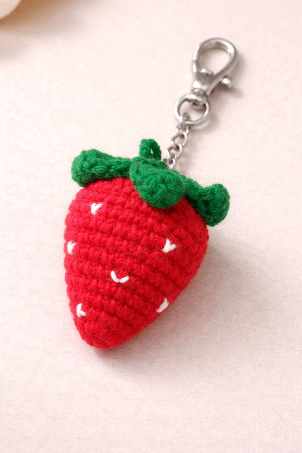Add a cute handmade touch to your accessories with this handmade crochet strawberry charm. Crafted from soft yarn, the design features a bright red strawberry shape with stitched seed detailing and green crochet leaves on top, giving it a playful and aesthetic look. ⚠️ This product does NOT include any metal ring, hook, clasp, or chain. It is sold as a standalone crochet charm, perfect for attaching to your own key ring, lobster clasp, zipper pull, bag chain, or for use in DIY craft projects. Lightweight and decorative, this crochet fruit charm is ideal for bag charms, keychain making, gifting, or handmade accessory collections. Inferred: Handmade technique and yarn material inferred from crochet texture. Status: Partial — many fields inferred.