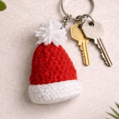 Handmade red and white crochet Santa hat keychain with pom-pom and metal key ring