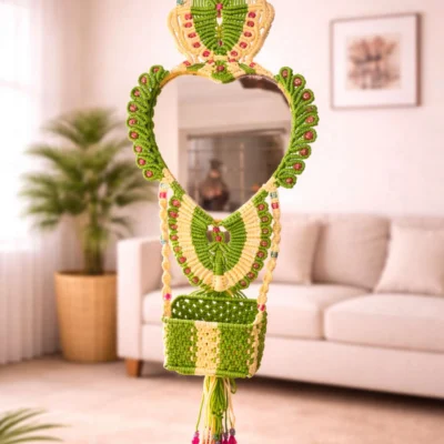 Handcrafted green and cream macramé mirror hanging with storage basket and tassels for wall décor