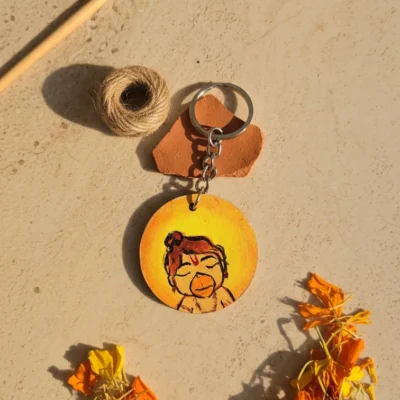 Handmade Bal Hanuman MDF round keychain with cute devotional design on yellow background