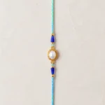 Handmade Pearl Oval Rakhi with Blue Crystal Beads for Brother
