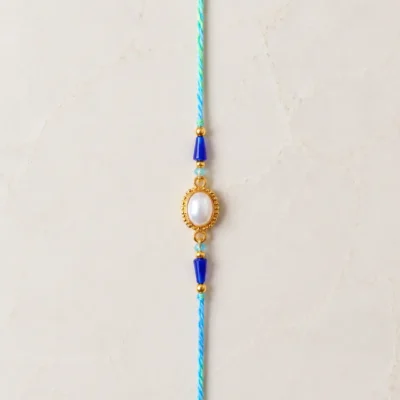 Handmade Pearl Oval Rakhi with Blue Crystal Beads for Brother