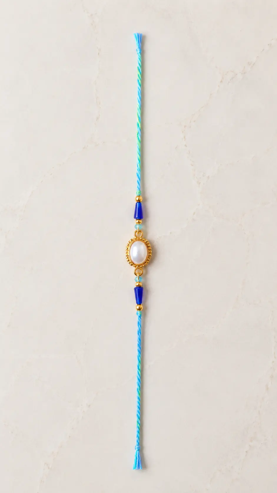 Handmade Pearl Oval Rakhi with Blue Crystal Beads for Brother