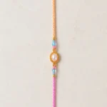 Handmade Pearl Oval Rakhi with Crystal Beads for Brother