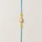 Handmade Pearl Oval Rakhi with Green Beads for Brother
