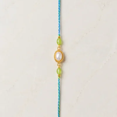 Handmade Pearl Oval Rakhi with Green Beads for Brother