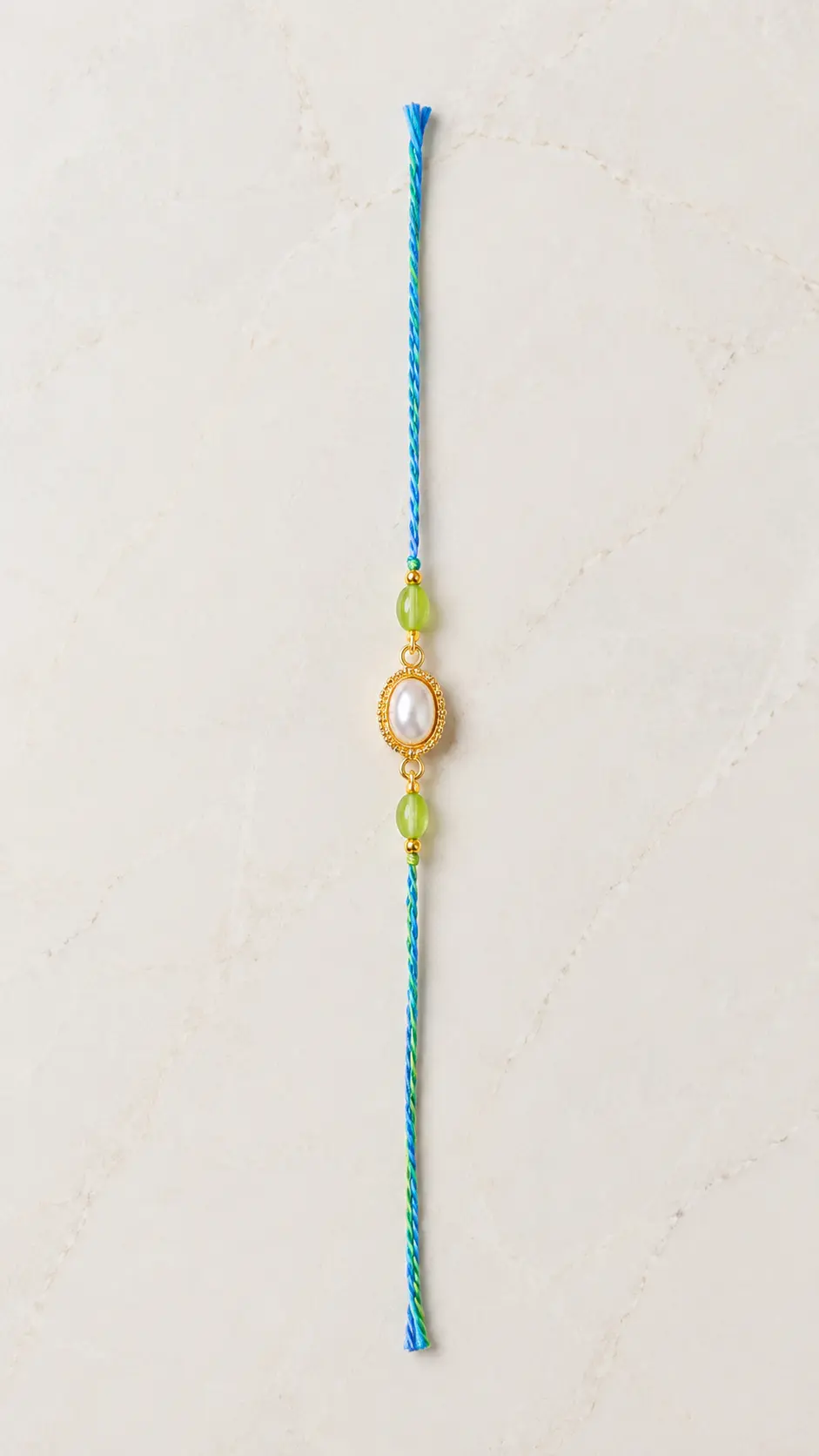 Handmade Pearl Oval Rakhi with Green Beads for Brother